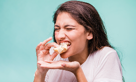 Woman experiencing difficulty biting into food