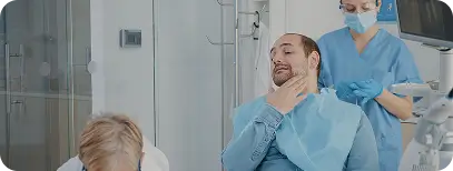 Dentist checking on a patient's jaw during a TMJ follow-up visit