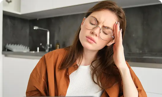 Woman experiencing headaches and facial pain