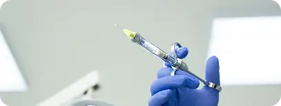 Dentist administering local anesthesia before gum surgery