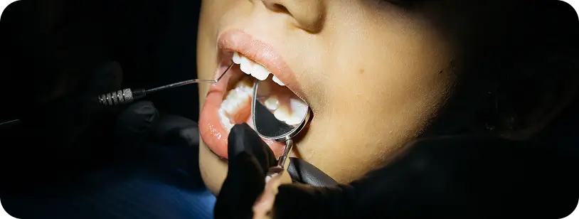 Periodontist examining a patient's gums during initial consultation