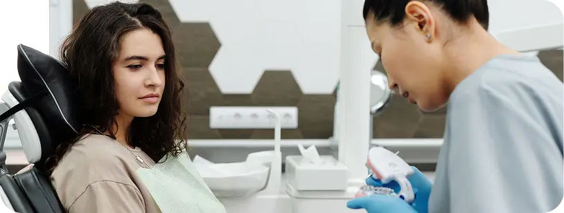 Dentist explaining recovery and aftercare instructions to a patient