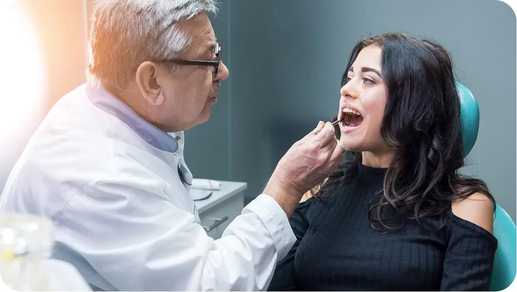 Dentist reviewing jaw diagnostics with a patient for TMJ treatment