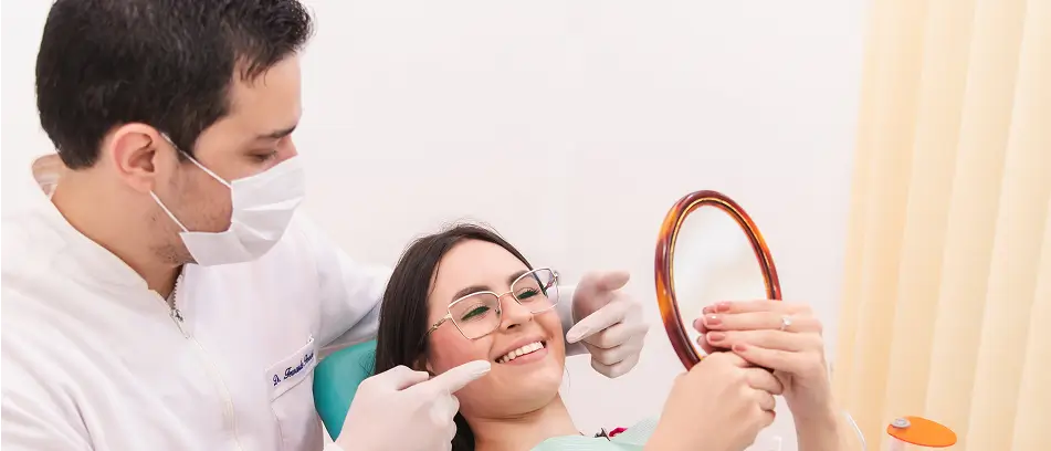 Dentist examining patient during a routine six-month dental checkup